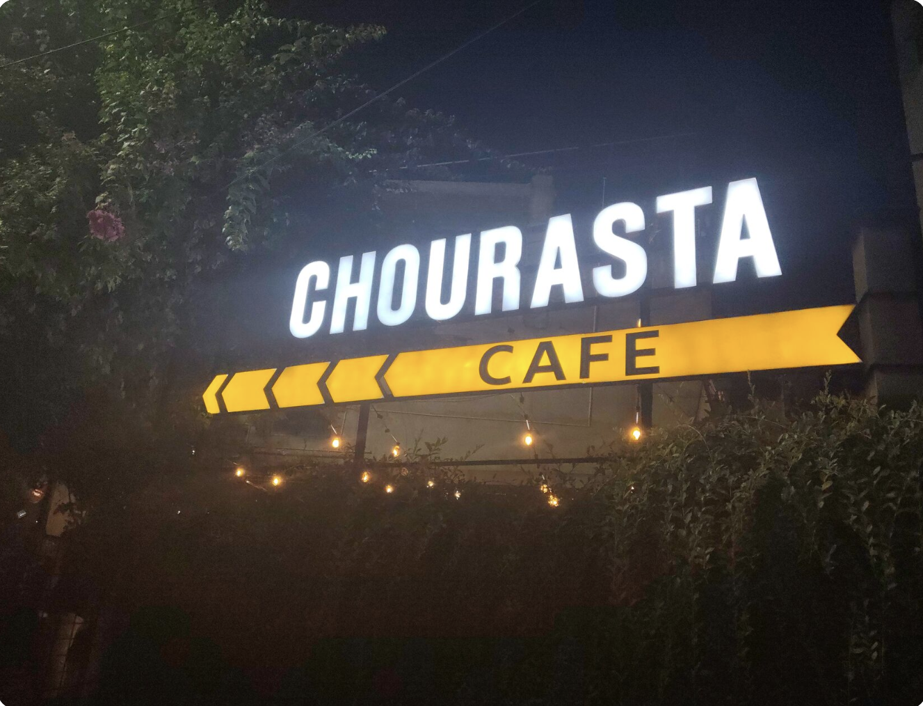 Chourasta Cafe lit-up signboard at night